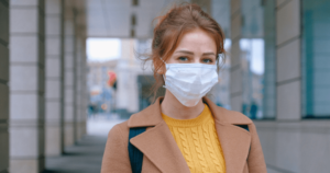 A woman wearing a face mask outside during quarantine