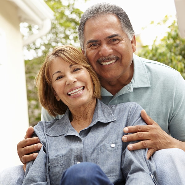 Mature couple smiling as they embrace
